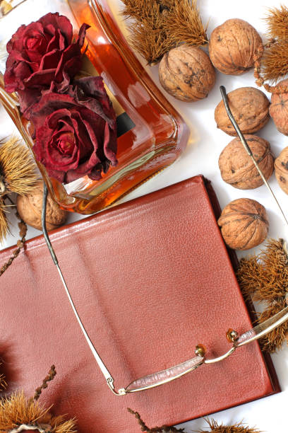 istock Composition. Cognac, a closed book, glasses and chestnuts 1171048060