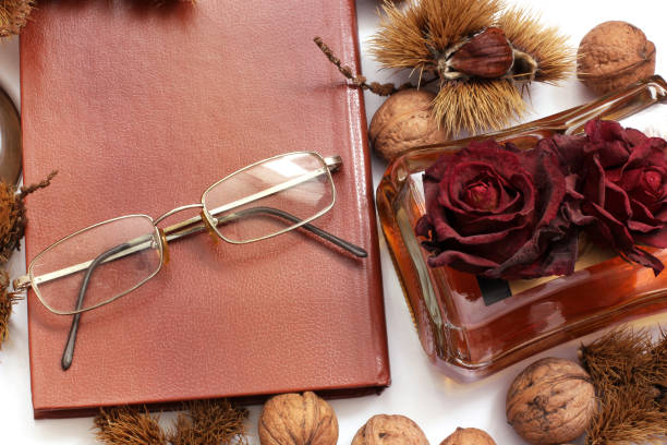 Composition. Cognac, a closed book, glasses and chestnuts