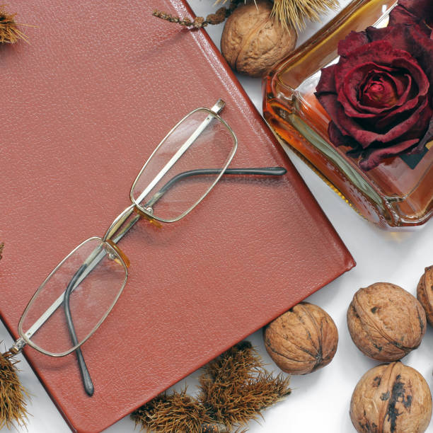 istock Composition. Cognac, a closed book, glasses and chestnuts 1171048130