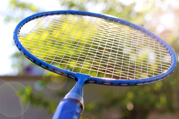 istock Badminton racket close up against a background of trees 1171050294