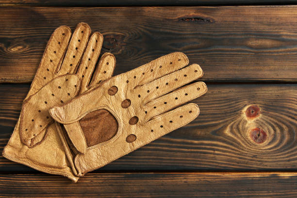 istock Leather gloves on a wooden background 1171059150