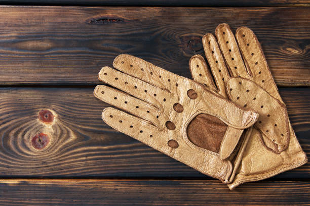 istock Leather gloves on a wooden background 1171059225