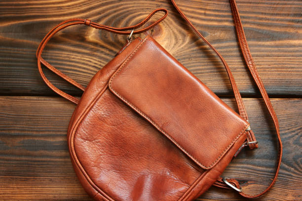 istock Leather bag on wooden background 1171060296