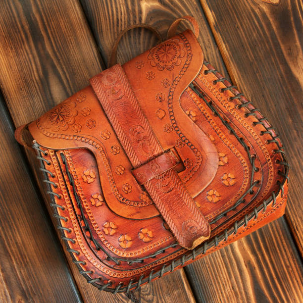 istock Leather bag on wooden background 1171060459