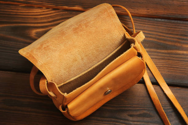 istock Leather bag on wooden background 1171060490