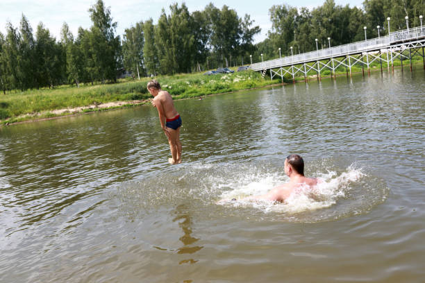 istock Child jumping into lake 1171061313