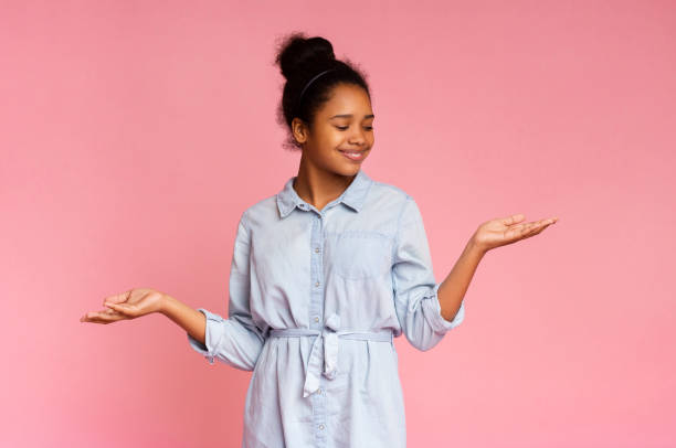 istock Smiling african american girl demonstrate something on her empty palms 1171061325