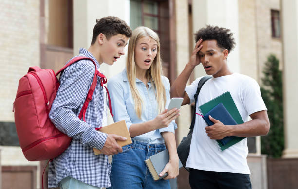 istock Shocked classmates checking exam results on smartphone 1171061630