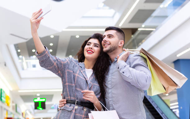 istock Successful couple making selfie after shopping in mall 1171061781