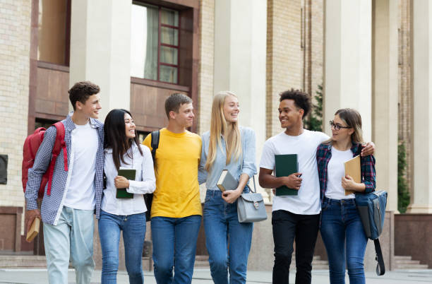 istock Student friends walking in university campus, copy space 1171062713