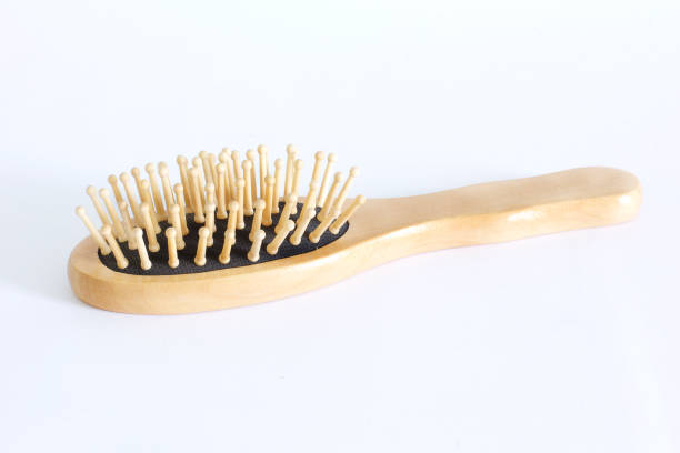 Wooden massage hairbrush on a white background stock photo