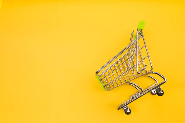 istock supermarket trolley on yellow background 1171062906