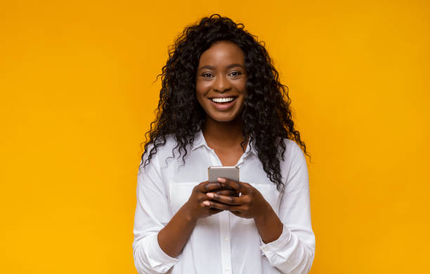 istock Happy african american girl using her smartphone 1171062959