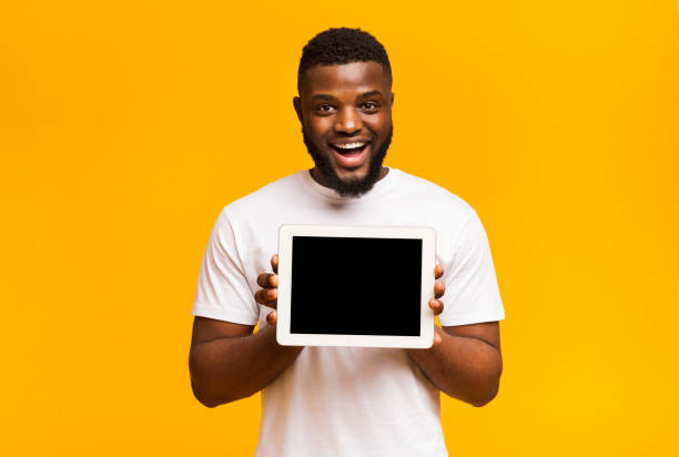 istock African american man showing blank digital tablet screen 1171062985