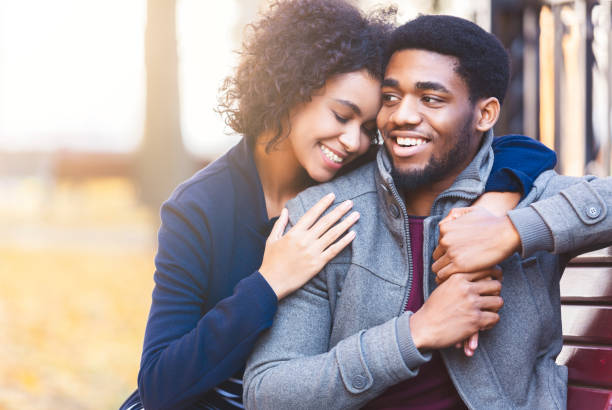 istock Curly black girl hugging her man with big love 1171063101