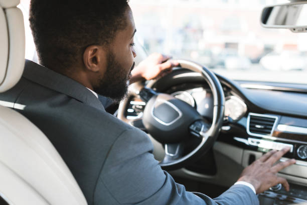 rijden met comfort. zakenman aanraken dashboard in de auto - chauffeur beroep stockfoto's en -beelden