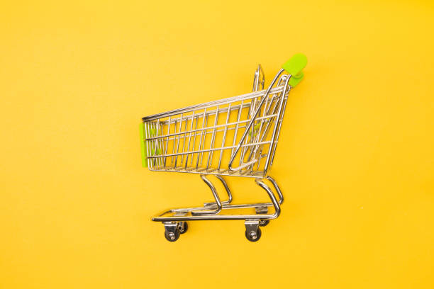 istock supermarket trolley on yellow background 1171063210