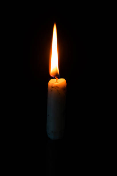 istock burning candle in the dark 1171063895