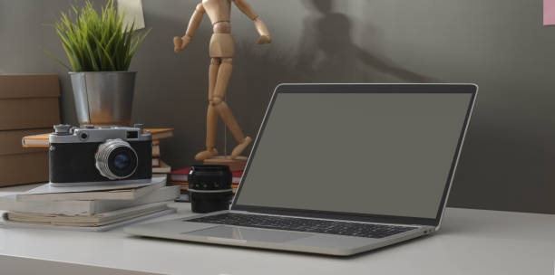 istock Minimal photographer workplace with open laptop and vintage camera 1171064278