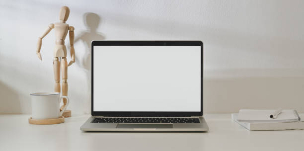 istock Blank screen laptop computer in minimal workplace with  office supplies and decorations 1171064292