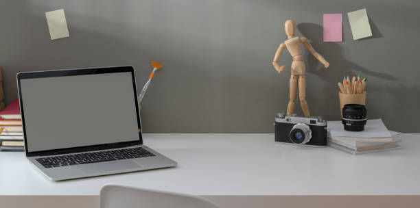 istock Comfortable workplace with open laptop and vintage camera with copy space 1171064328