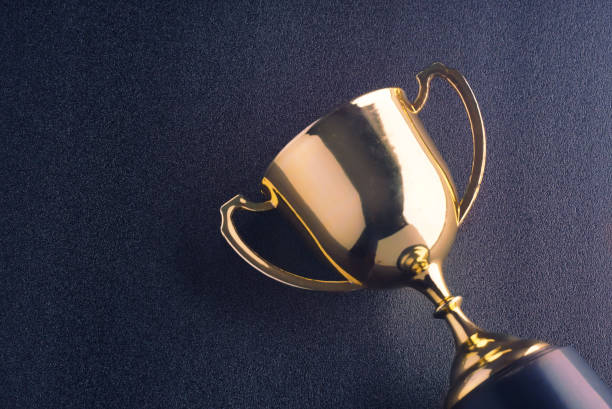 istock Gold shinny trophy lay on black background. 1171064538