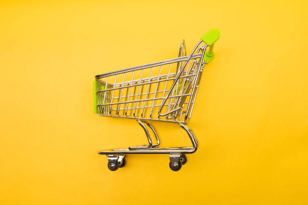istock supermarket trolley on yellow background 1171064630
