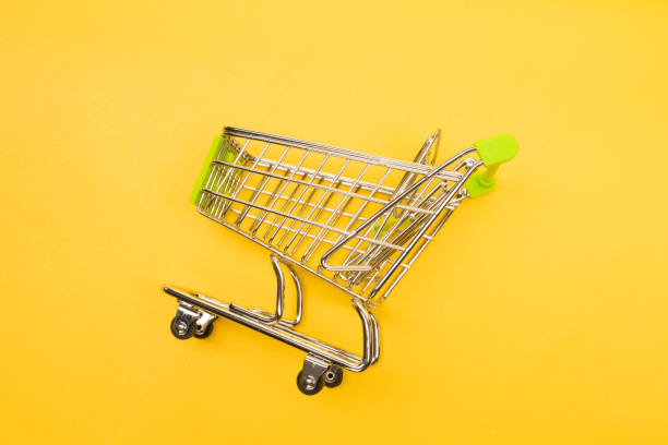 istock supermarket trolley on yellow background 1171064705