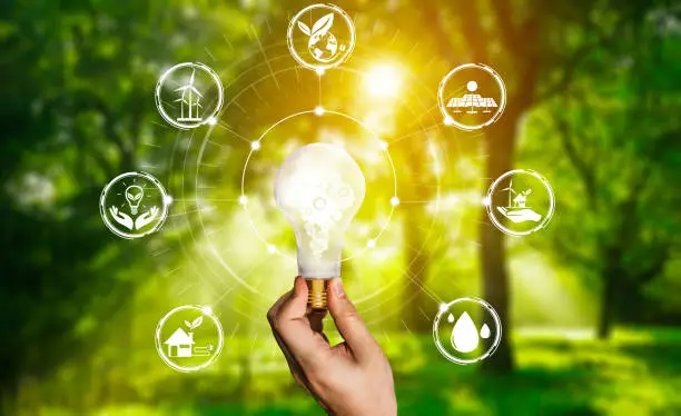 Green energy innovation light bulb with future industry of power generation icon graphic interface. Concept of sustainability development by alternative energy.