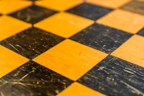 istock Yellow and black chess squares, located at an angle. Chess game background. 1171070391