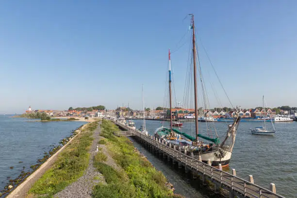 Historic sailing ship moored at pier of Dutch fishing village Urk