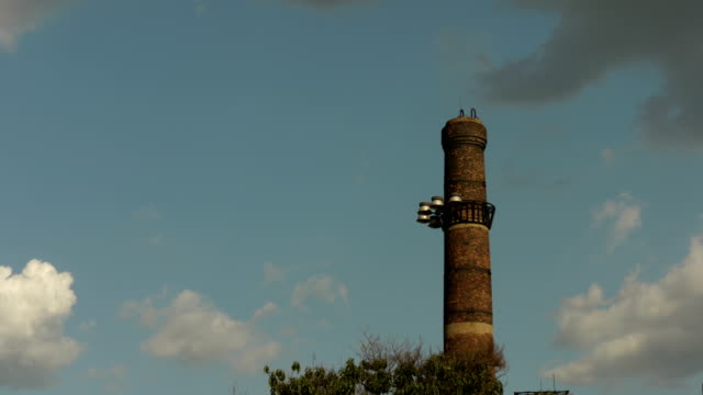 The abandoned chimneys of mines are set against the blue sky