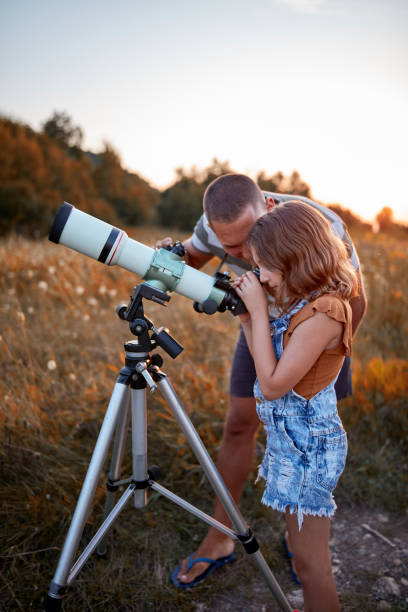 istock Father and daughter observing the sky with a telescope. 1171079694