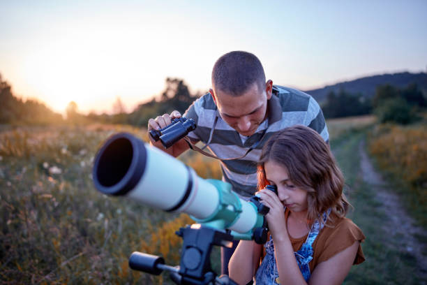 istock Father and daughter observing the sky with a telescope. 1171079730