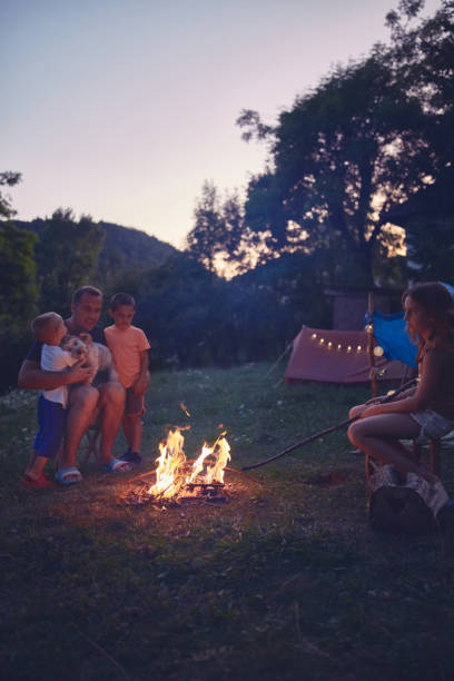 istock Father with children making a camping fire in the backyard. 1171079876