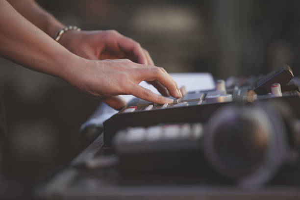 istock Professional beatmaker playing new beats with drum machine device on stage at rap music concert 1171079970