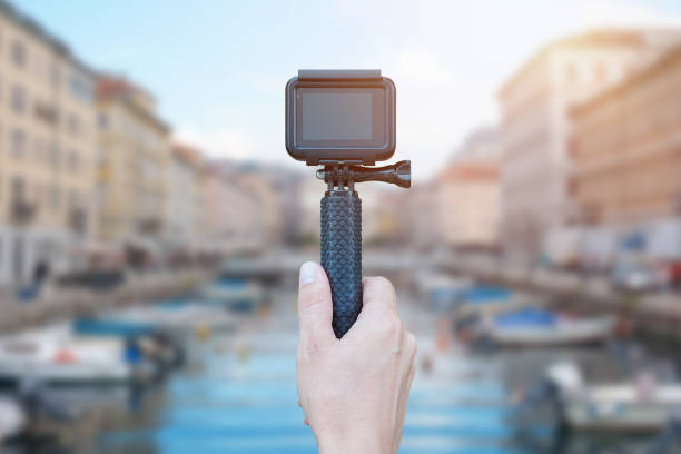 istock Action camera on stick in hand recording city concept. Blank screen for mockup. 1171080986