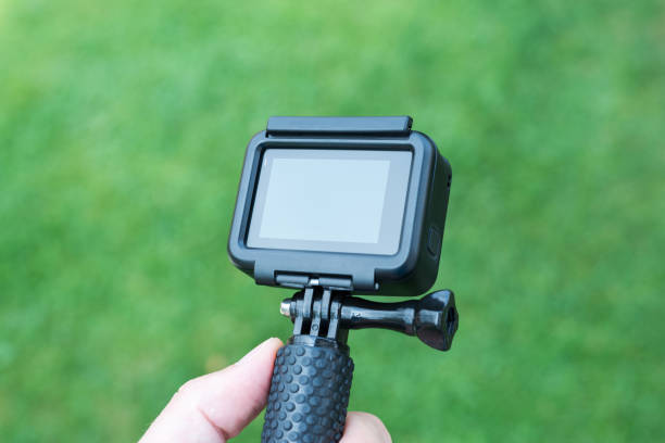 istock Action camera close-up on stick. Blank screen for mockup. 1171081010