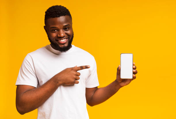 istock Smiling african american man pointing at cellphone with blank screen 1171081411