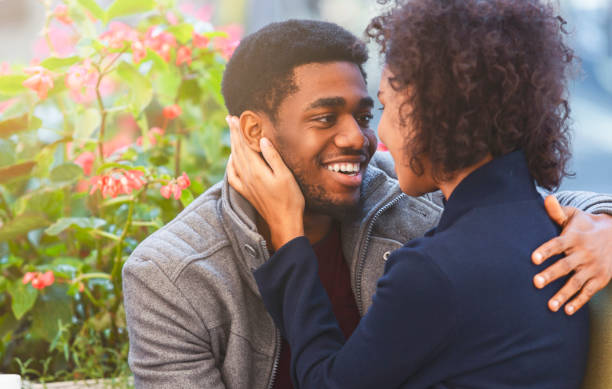 istock Afro couple in love telling each other sweet words, hugging 1171081990