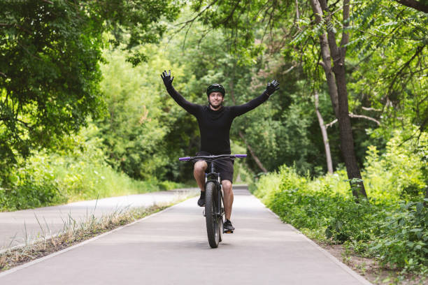 istock Young male cyclist celebrating victory with hands up 1171082555