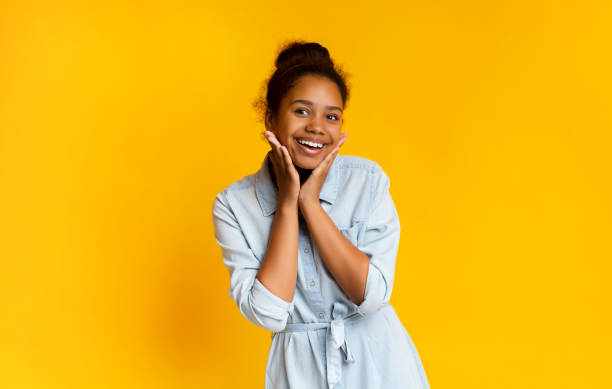 istock Excited black schoolgirl smiling on camera and touching her face 1171082690