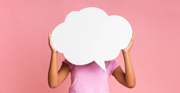 istock Empty speech bubble at girl's hands on pink background 1171085606