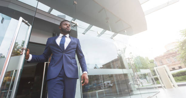istock Young african job seeker leaving building after interview 1171085646