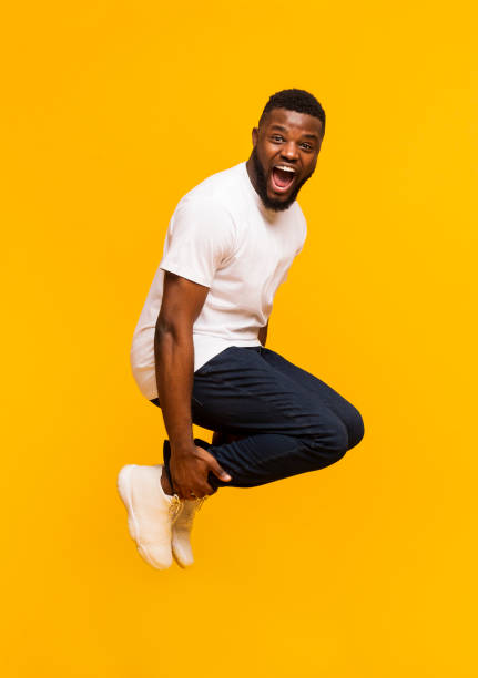 istock Emotional black guy jumping in bomb style and shouting 1171085911