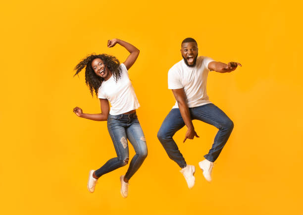 istock Super excited afro couple leaping at studio 1171086897