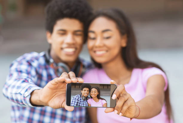 istock Young loving couple making selfie on smartphone camera 1171088640