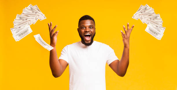 istock Euphoric black man throws up lots of dollars 1171089768