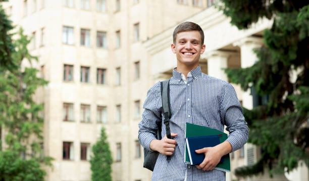 istock Happy guy student waiting for lessons near university outdoor 1171089894