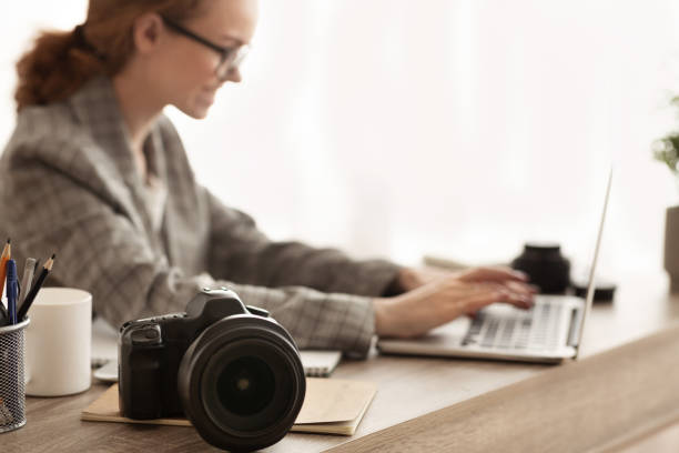 istock Woman working with photocamera and laptop, off loading files 1171089942